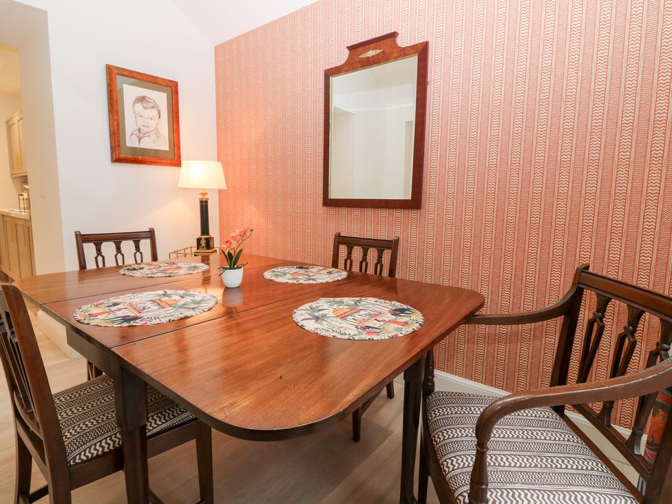 A dining room with a table and chairs at 4 East Camno Farm Cottages near Meigle