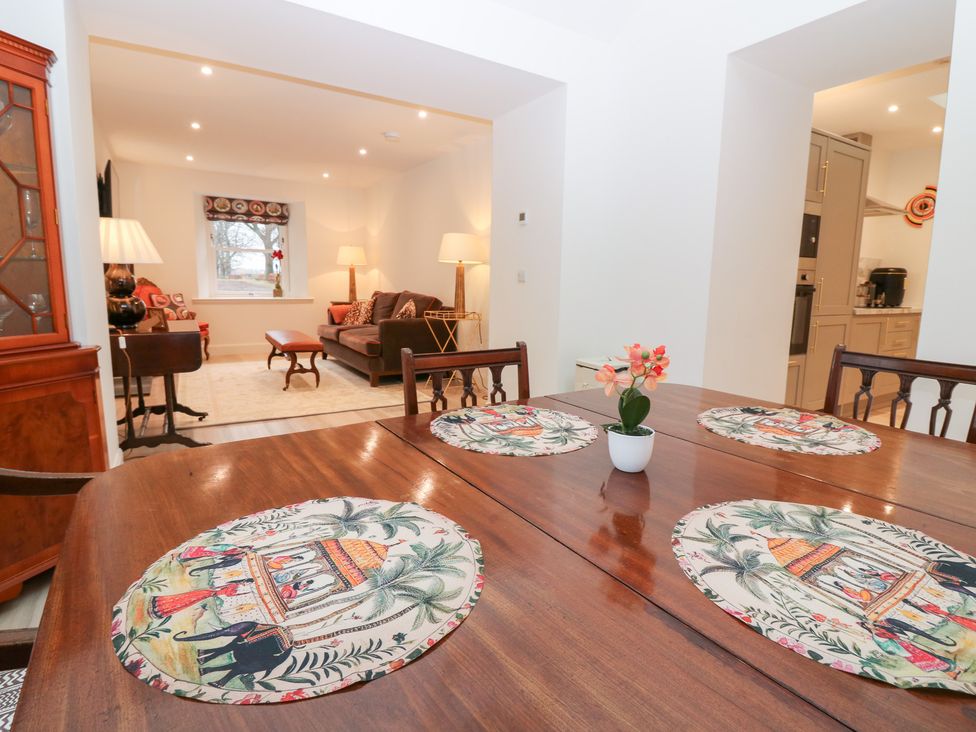 A dining room with a table and chairs at 4 East Camno Farm Cottages Near Meigle