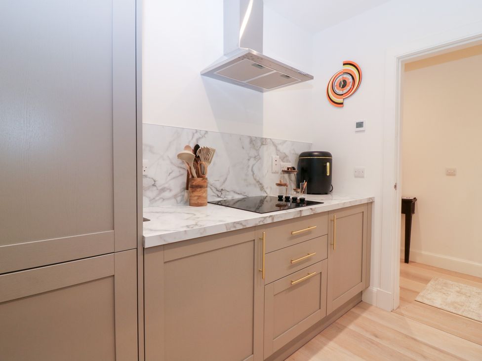 A kitchen with cabinets and a stove at 4 East Camno Farm Cottages Near Meigle