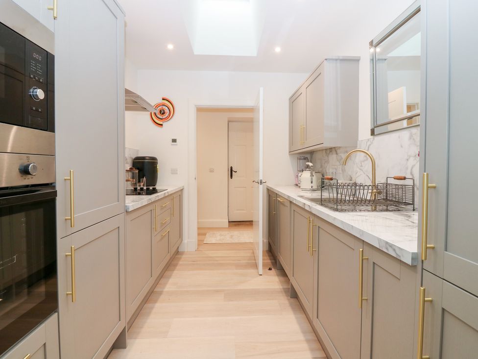 A kitchen with cabinets and appliances at 4 East Camno Farm Cottages near Meigle