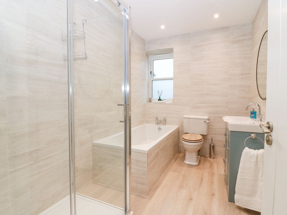 A bathroom with a bathtub and shower at 4 East Camno Farm Cottages Near Meigle