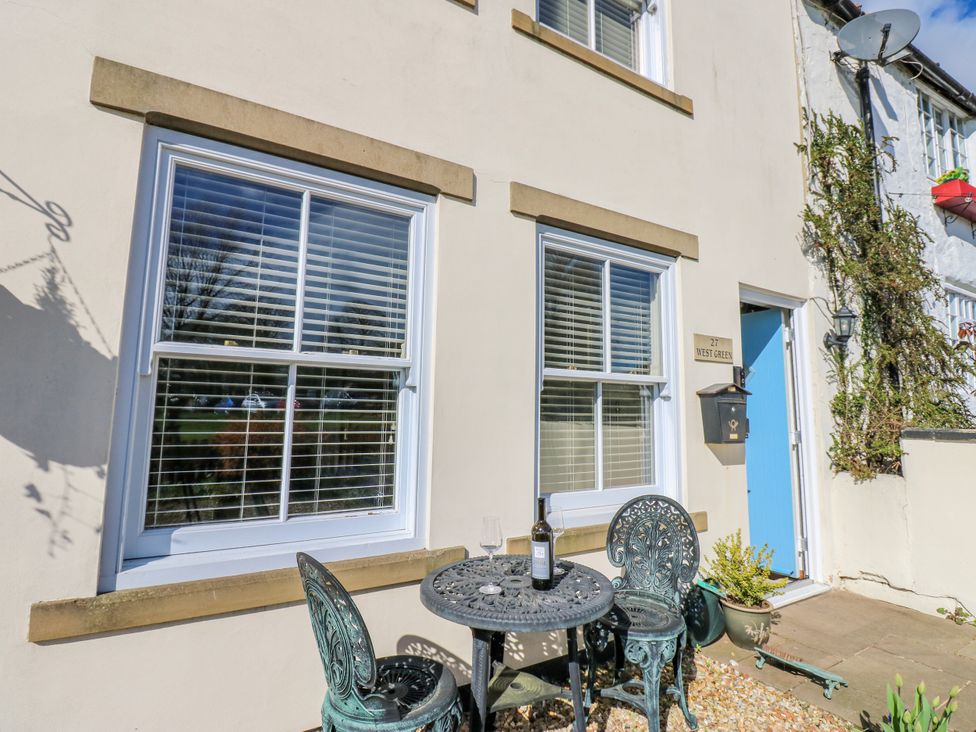 An outdoor area with a table and chairs at 27 West Green 