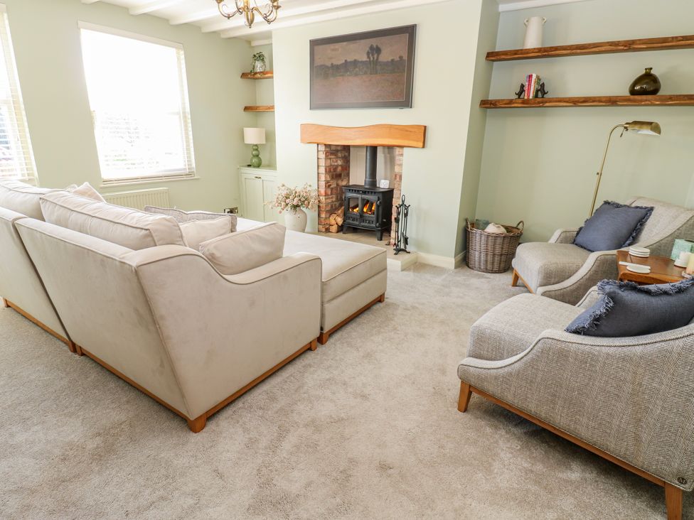 A living room with a sofa and fireplace at 27 West Green