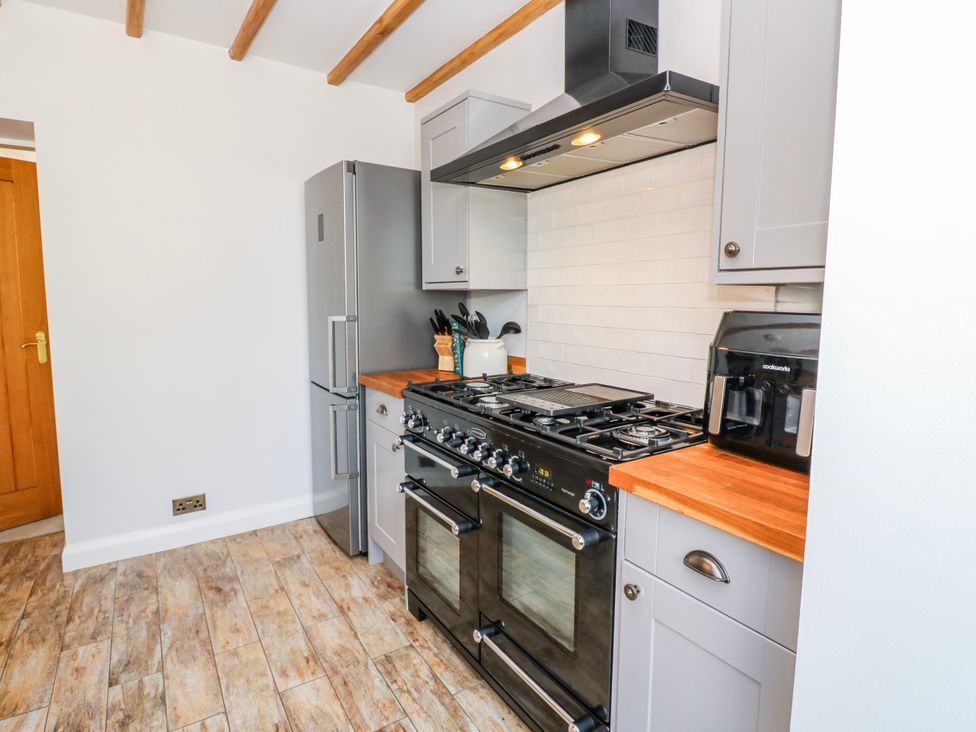 A kitchen with refrigerator and stove at 27 West Green