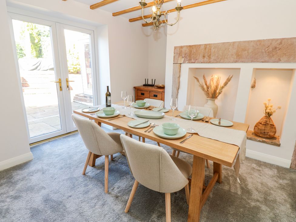 A dining room with a table set for dinner at 27 West Green 
