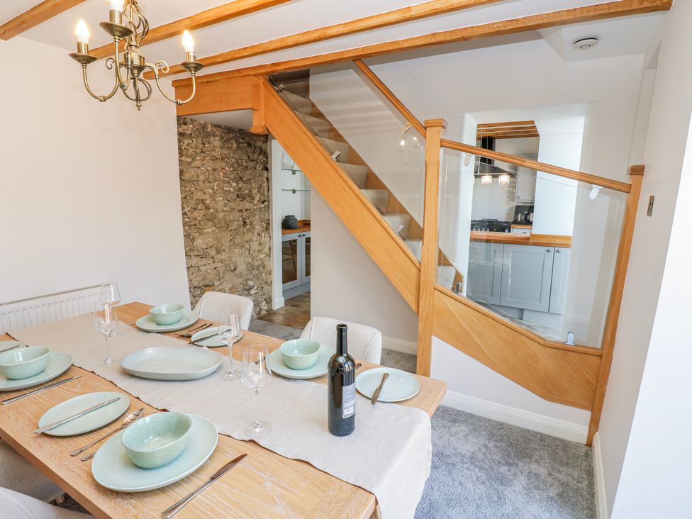 A dining room with a table set for meal at 27 West Green