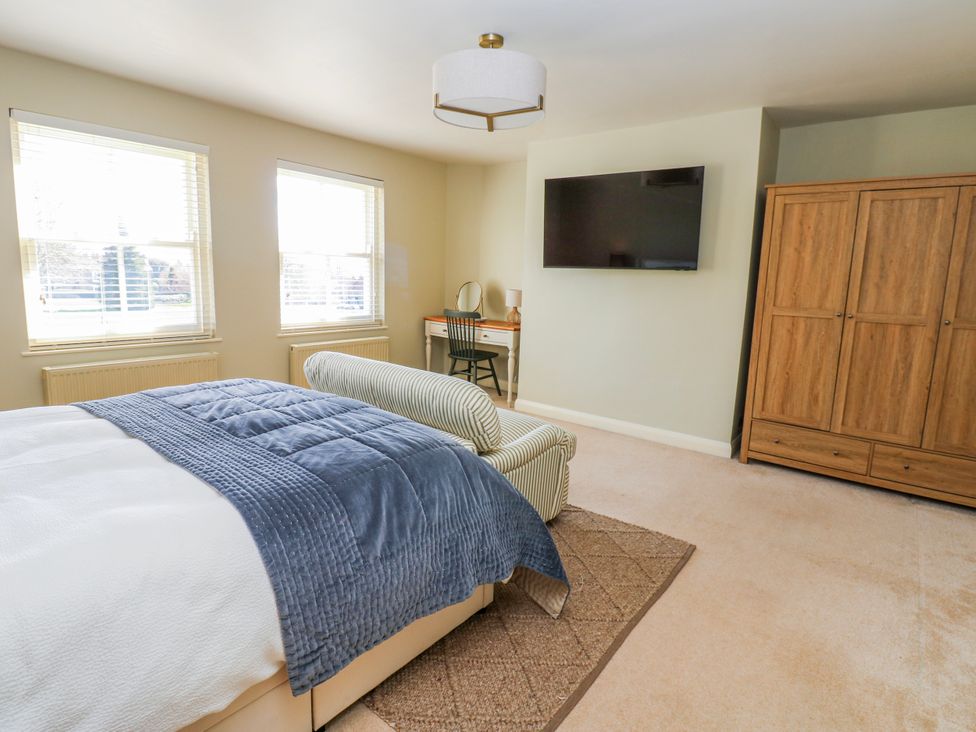 A bedroom with a bed and desk at 27 West Green