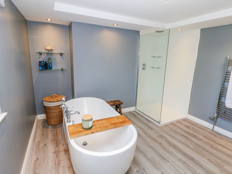 A bathroom with a bathtub and shower at 27 West Green