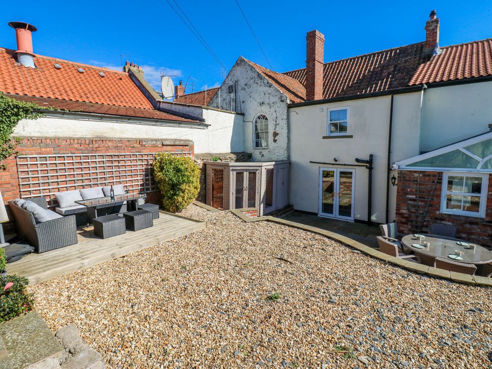 A garden with an outdoor seating set and gravel area at 27 West Green