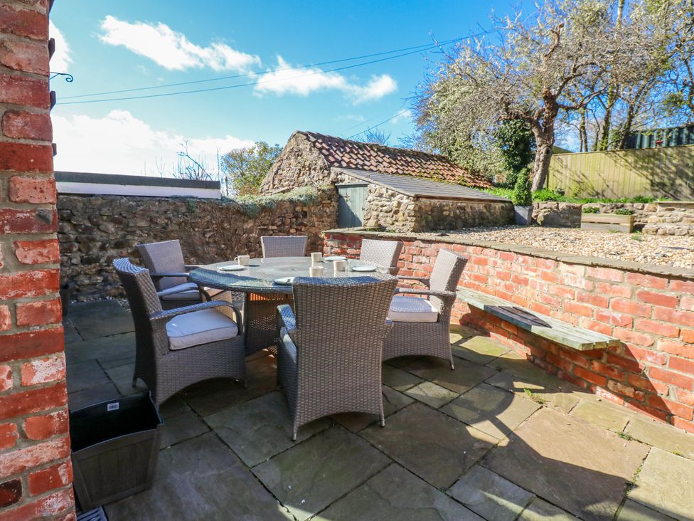 An outdoor dining area with a table and chairs at 27 West Green