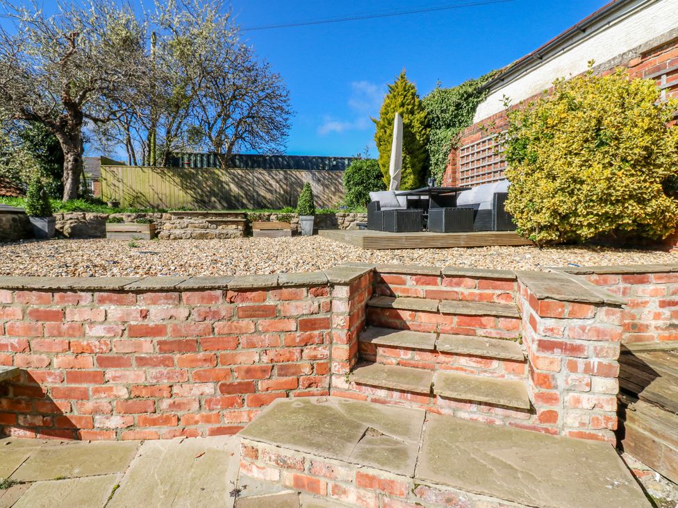 A garden with steps leading to outdoor furniture at 27 West Green