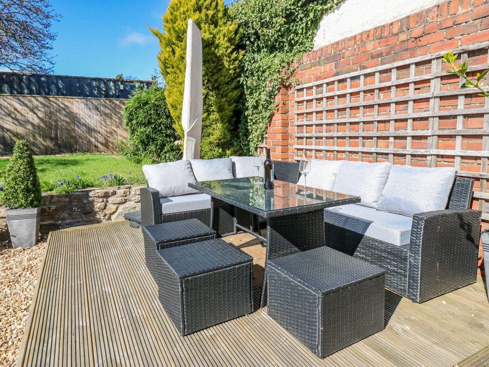 An outdoor seating area with a table and chairs at 27 West Green