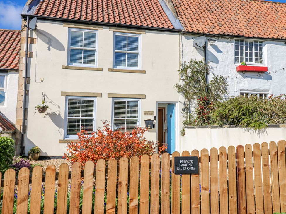 A house with a blue door and a sign for parking at 27 West Green