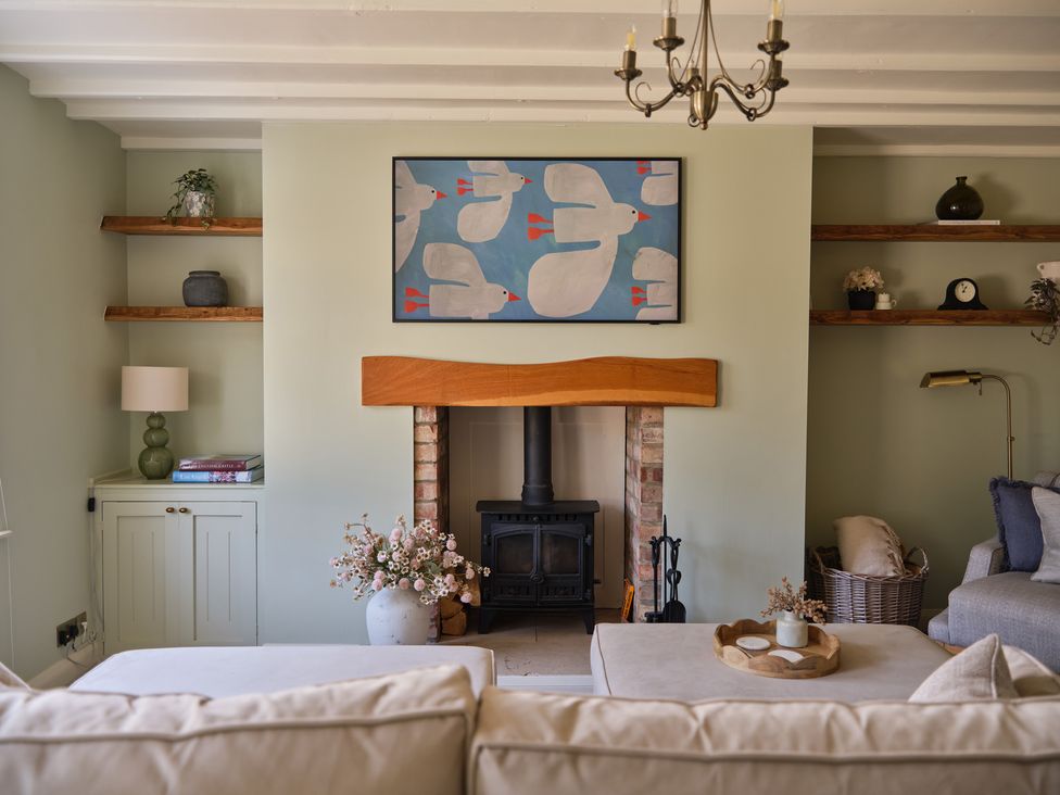A living room with a sofa and fireplace at 27 West Green in Heighington