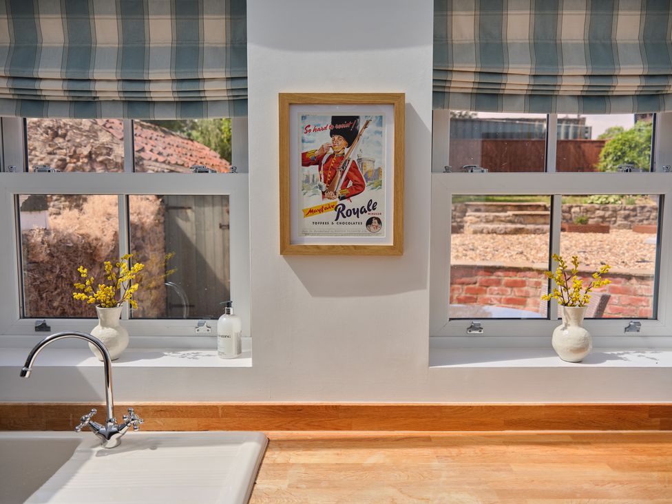 A kitchen with a sink and window at 27 West Green Heighington