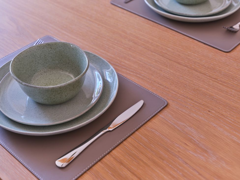 A dining table set with plates and a bowl at 27 West Green in Heighington