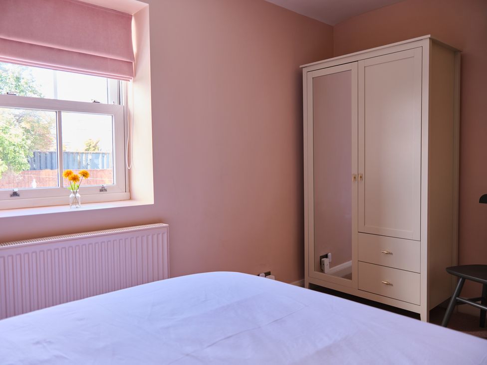 A bedroom featuring a wardrobe and a window at 27 West Green Heighington