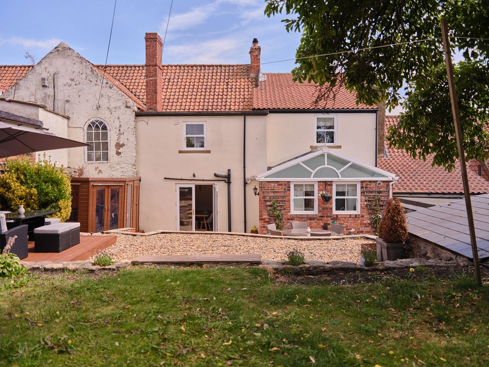 A house with garden visible in the background at 27 West Green Heighington