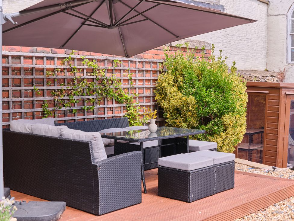 A garden area with seating and a table at 27 West Green, Heighington