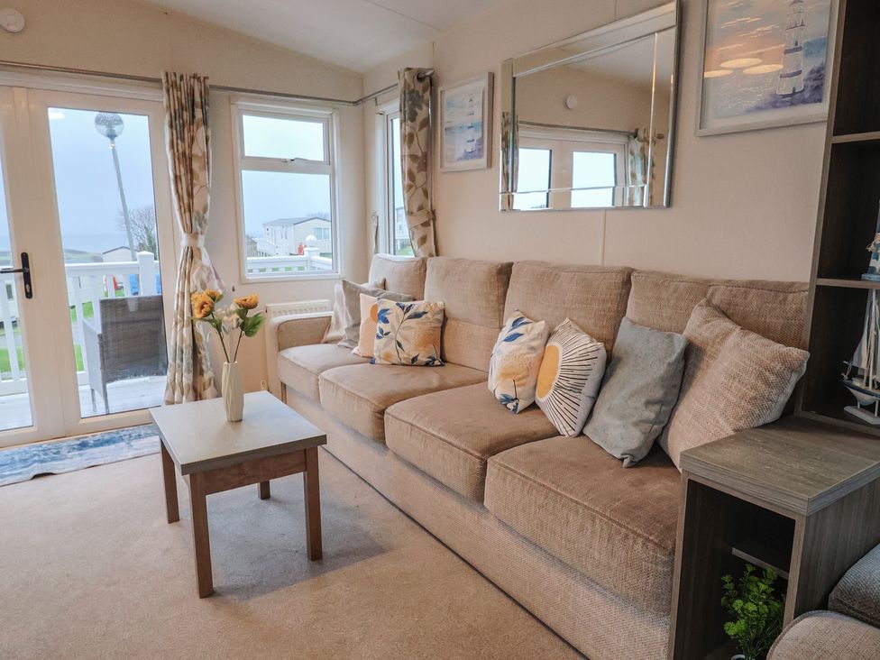 A living room with a sofa and coffee table at Gorse Hill 211 Exmouth