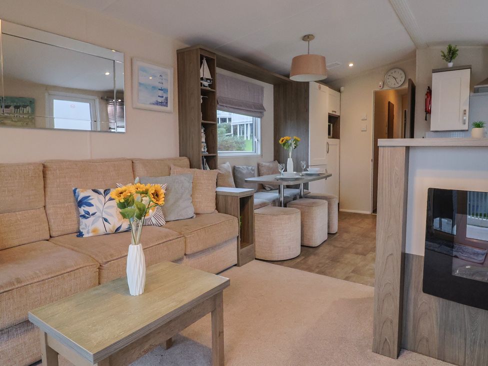 A living room with a sofa and dining area at Gorse Hill 211 Exmouth