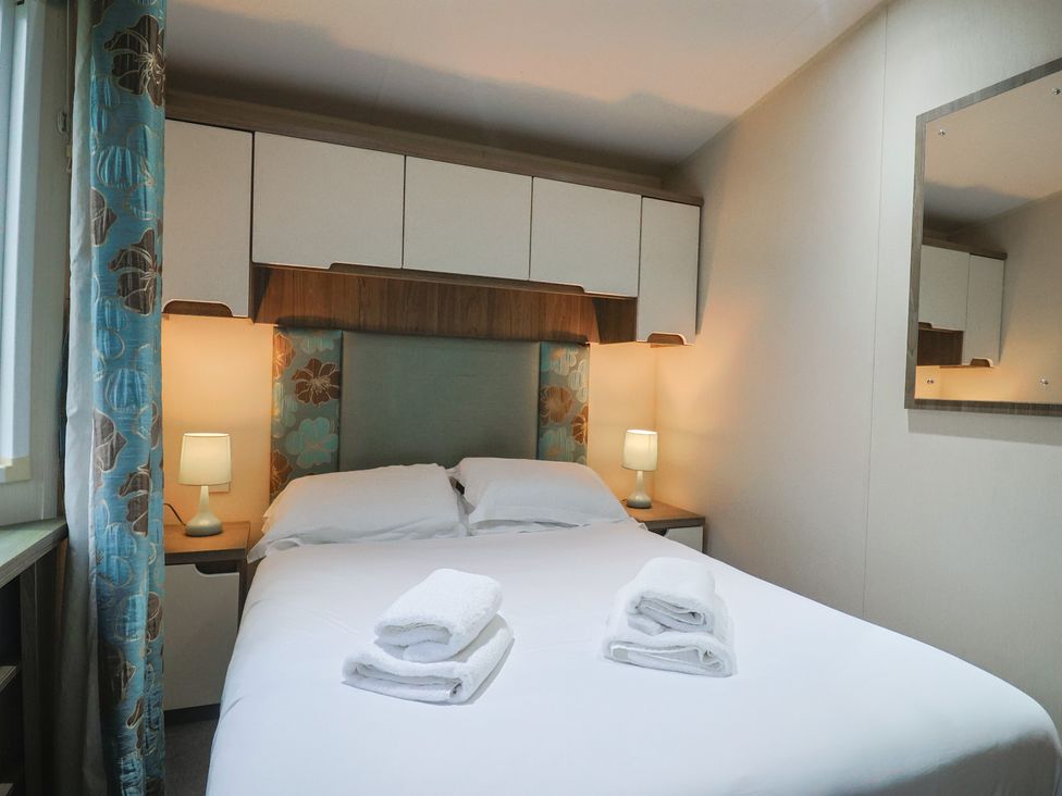 A bedroom with a bed and lamps at Gorse Hill 211 in Exmouth