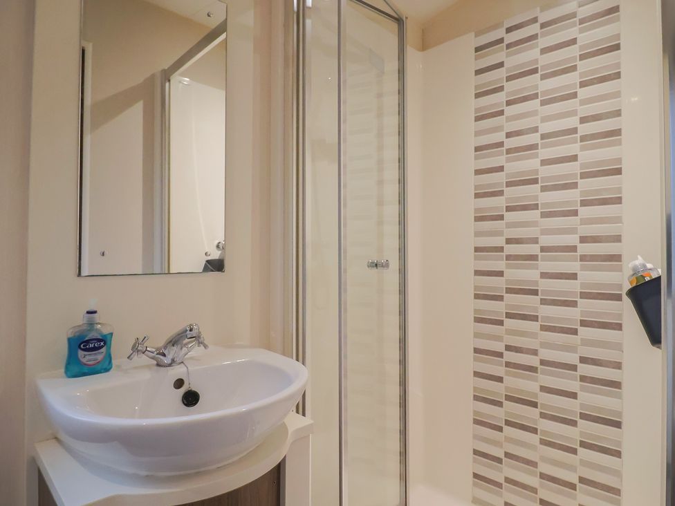A bathroom with a sink and shower at Gorse Hill 211 in Exmouth