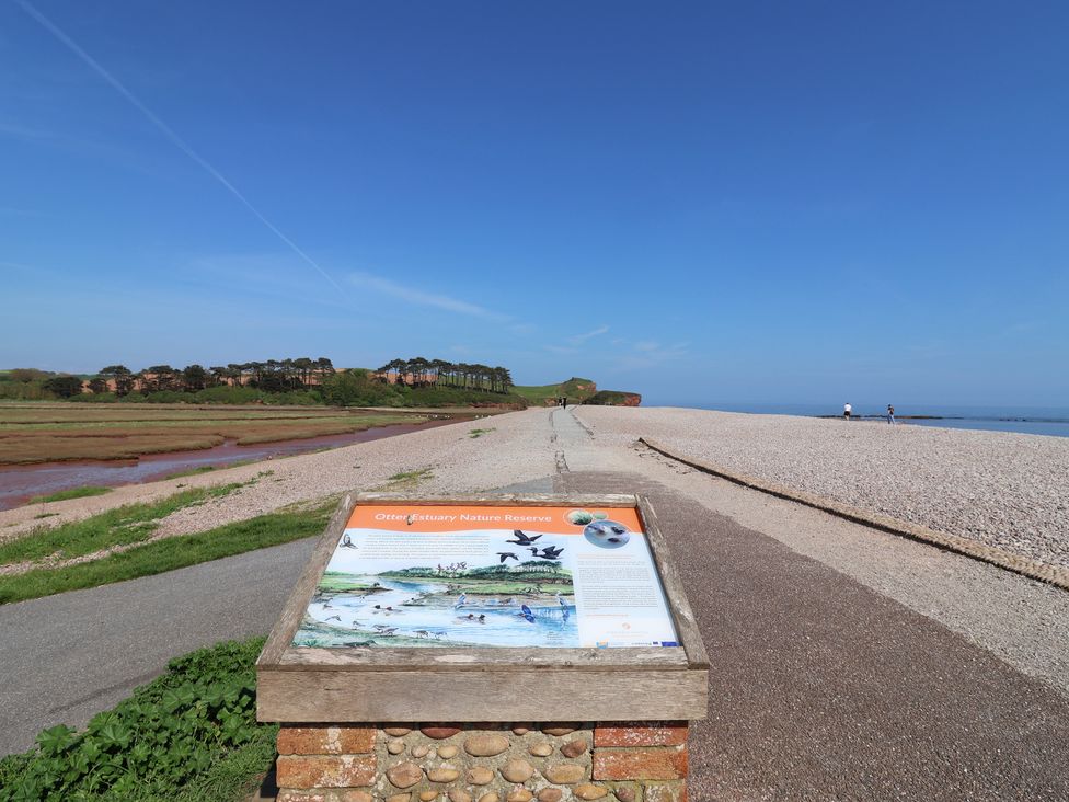 A nature reserve sign with path and water at Gorse Hill 211 in Exmouth
