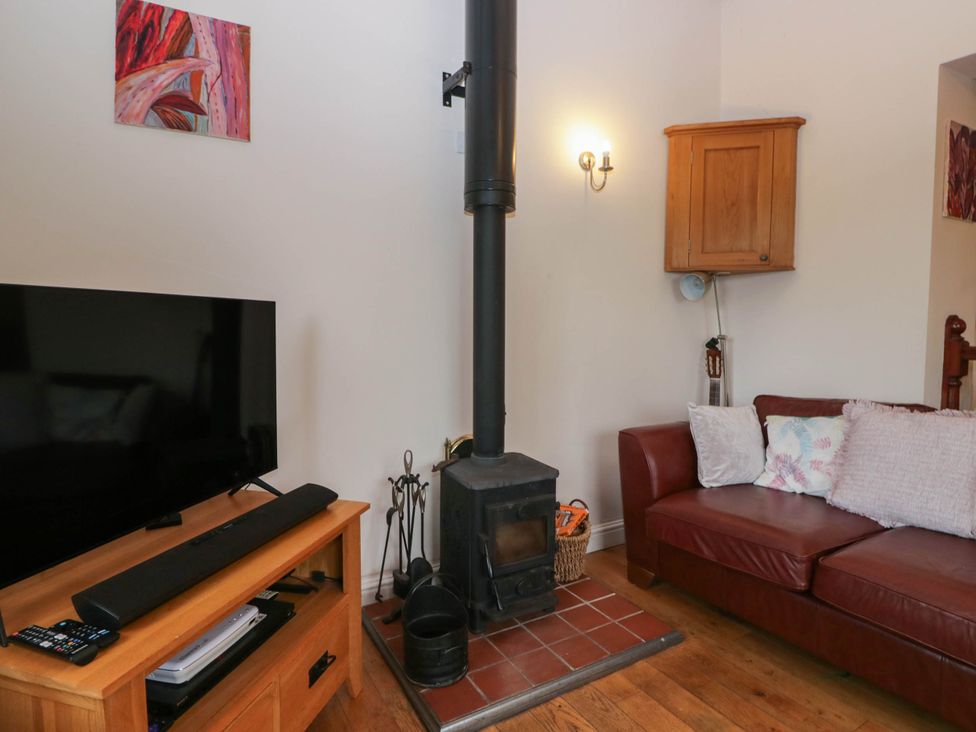 A living room with a television and stove at The Spinney near Milnthorpe