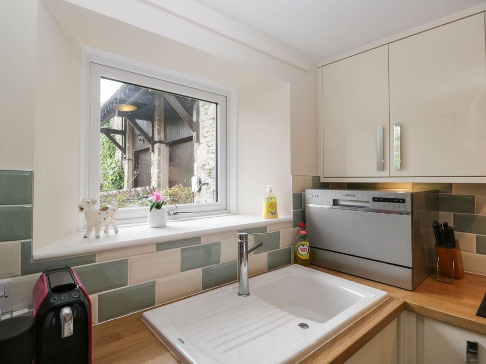 A kitchen with a sink and dishwasher at The Spinney near Milnthorpe