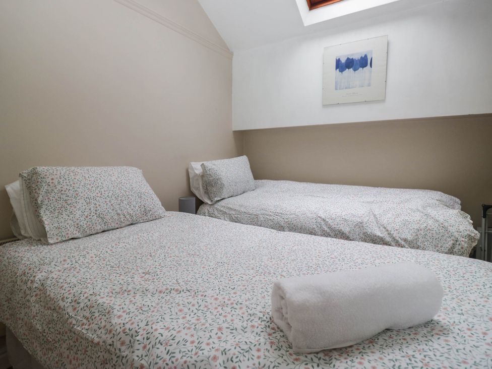 A bedroom with two beds and wall art at The Spinney near Milnthorpe