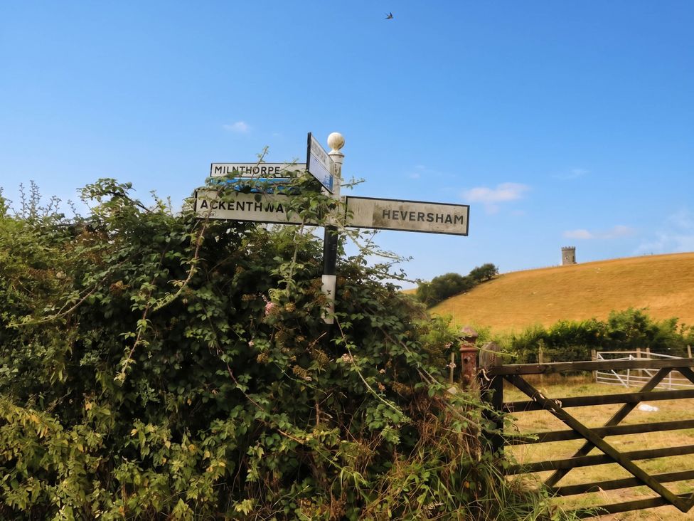 Directional sign at a junction near a field at The Spinney near Milnthorpe