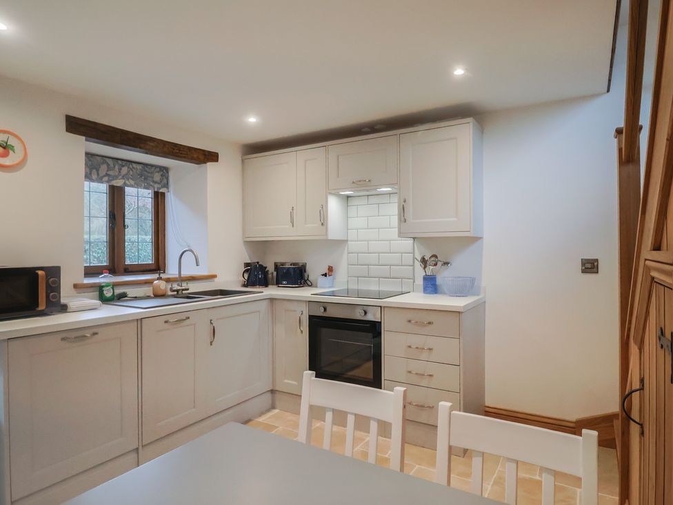 A kitchen with appliances and countertop at Rose Cottage in Wellington