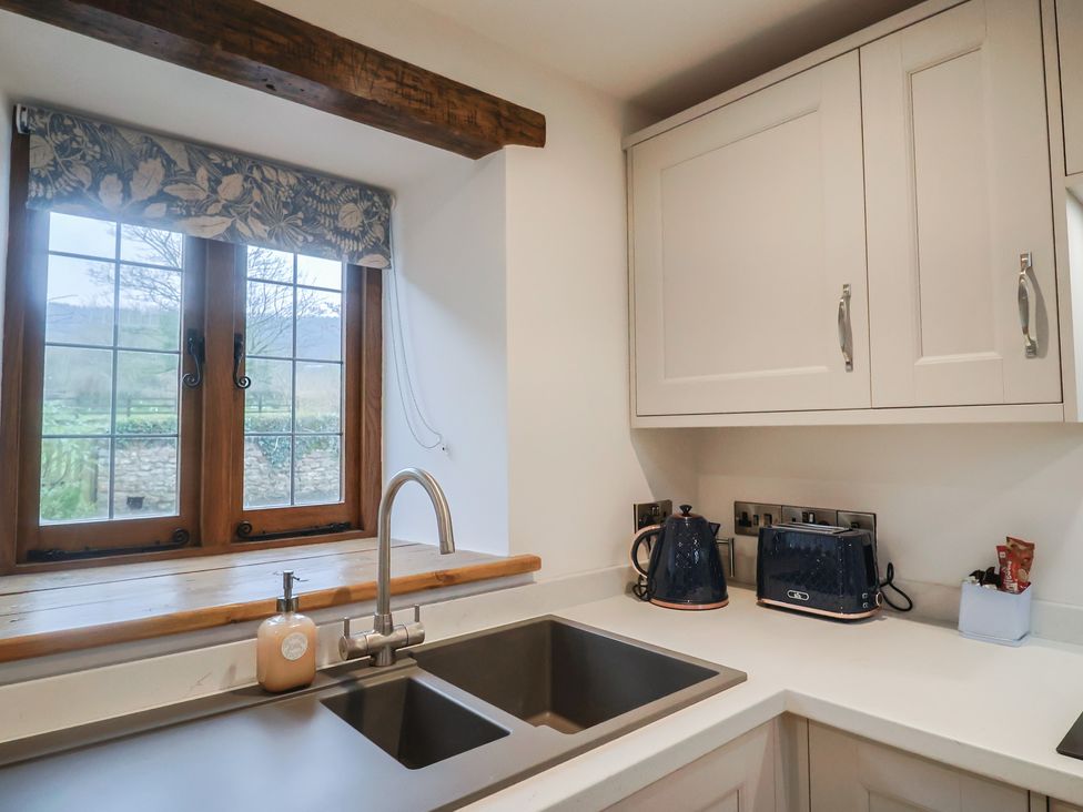 A kitchen with a window and sink at Rose Cottage in Wellington