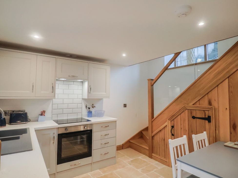 A kitchen with cabinets and appliances at Rose Cottage Wellington