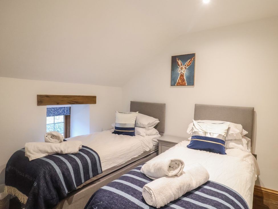 A bedroom with two beds and a window at Rose Cottage Wellington