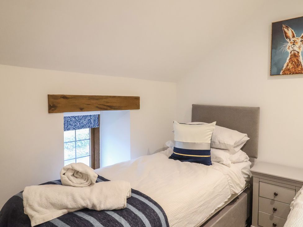 A twin bedroom with beds and a window at Rose Cottage in Wellington