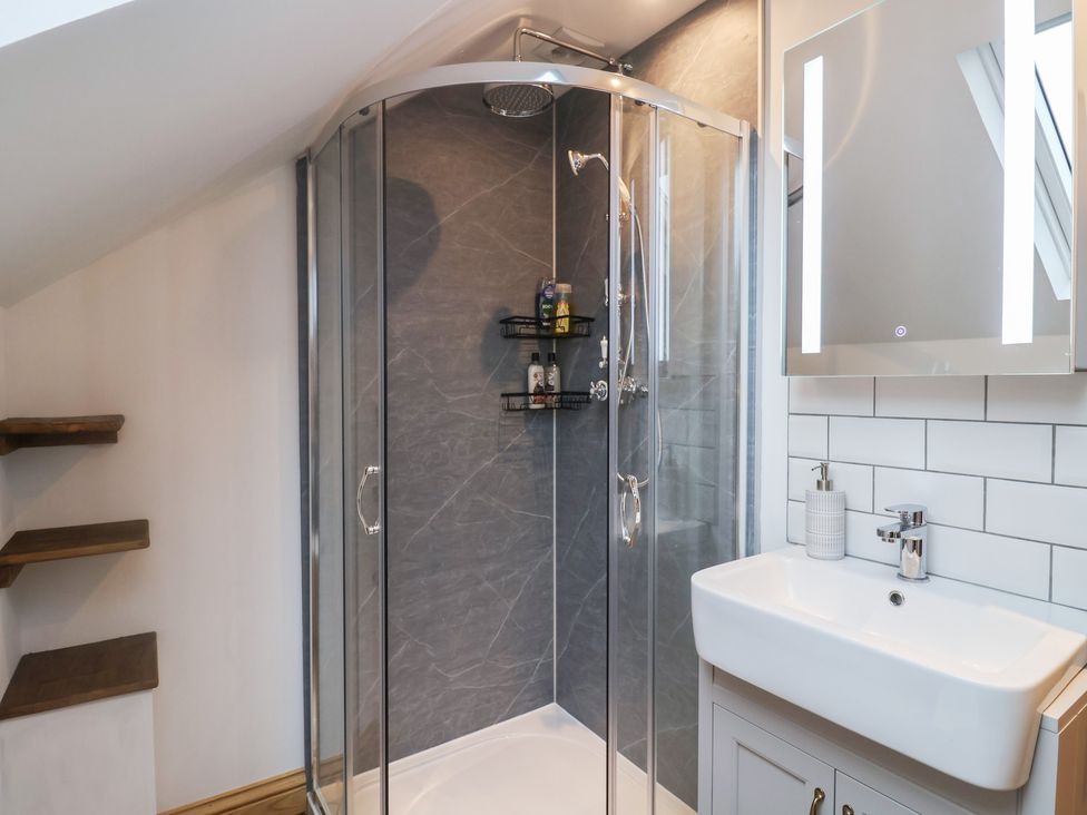 A bathroom with a shower and sink at Rose Cottage in Wellington