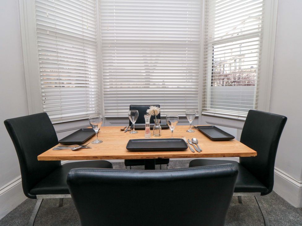 A dining room with a table set for a meal at Ground Floor 1 bed in Scarborough
