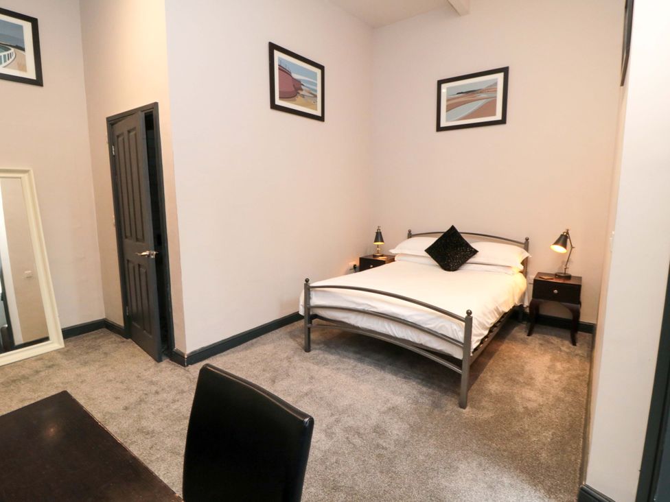 A bedroom with a bed and bedside table at Ground Floor 1 bed in Scarborough