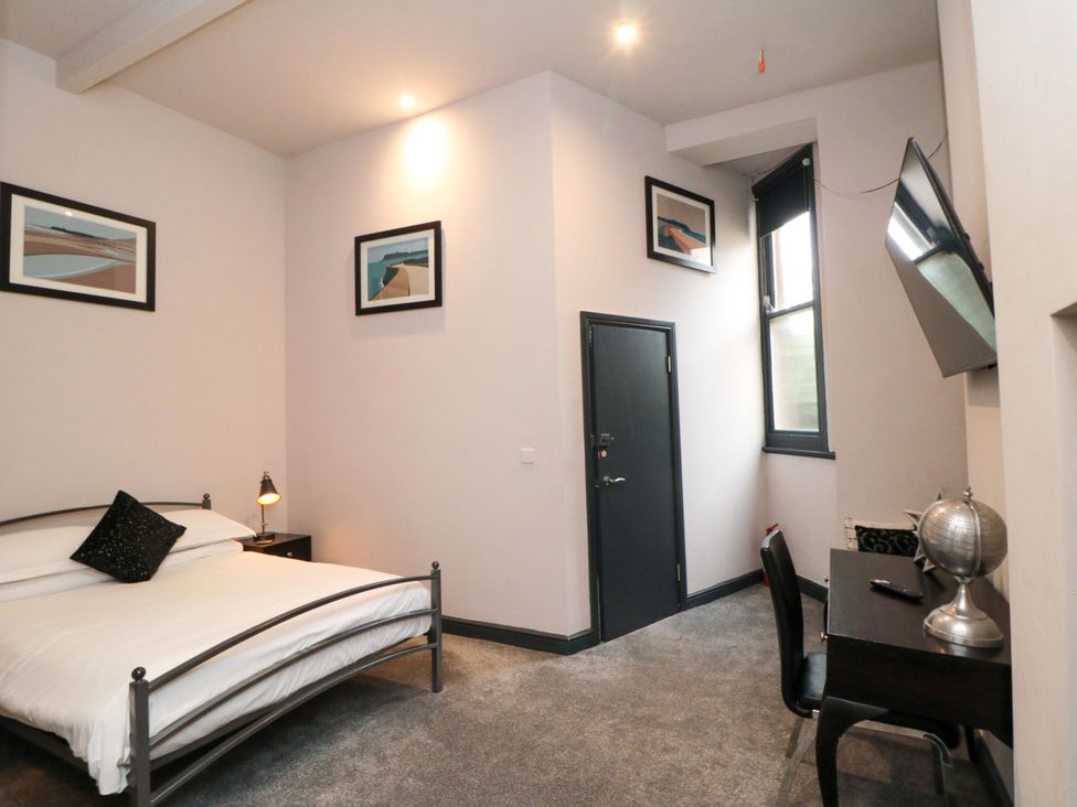 A bedroom with a bed and desk at Ground Floor 1 bed in Scarborough