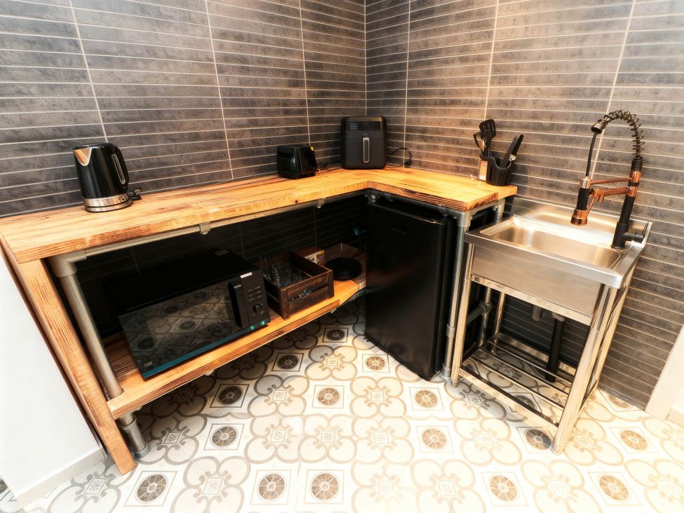 A kitchen with appliances and countertop at Craven Suite in Scarborough
