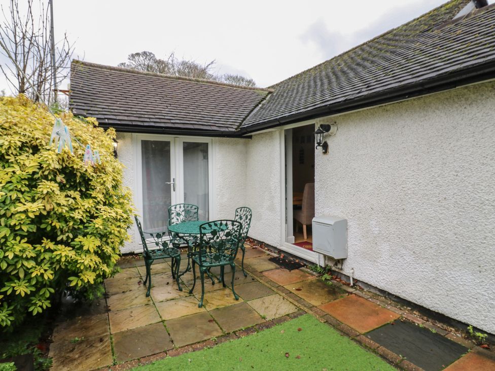 An outdoor patio with a table and chairs at The Enchanted House in Watford