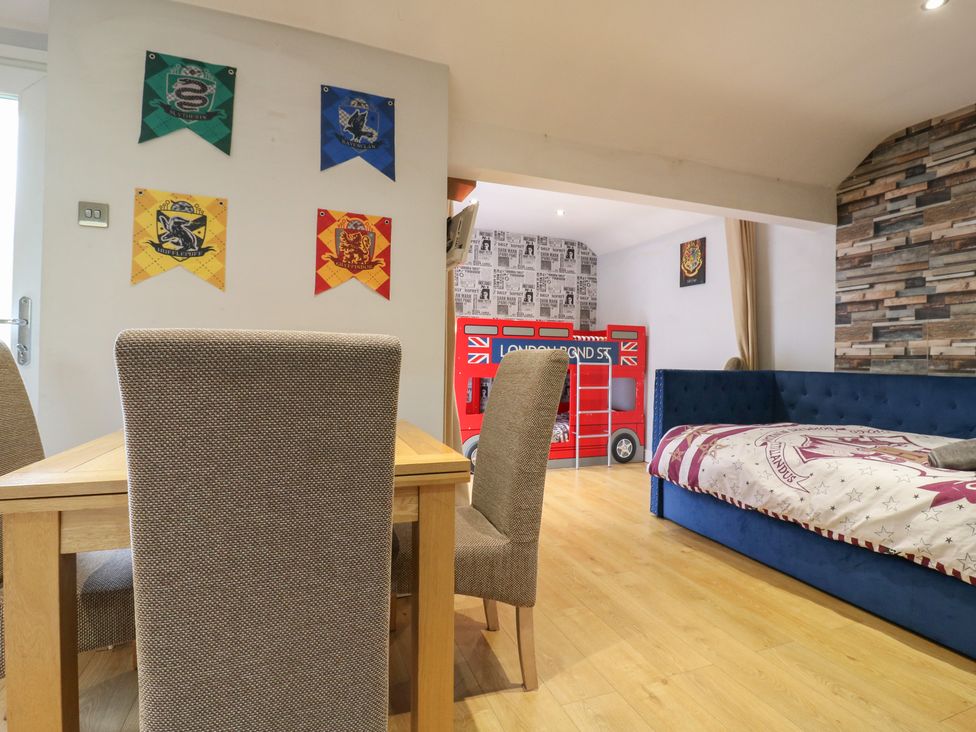 A bedroom with a dining area and themed decor at The Enchanted House in Watford