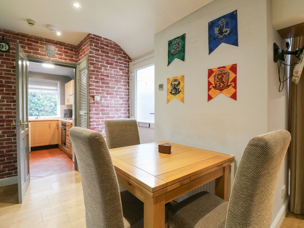 A dining room with a table and chairs at The Enchanted House in Watford