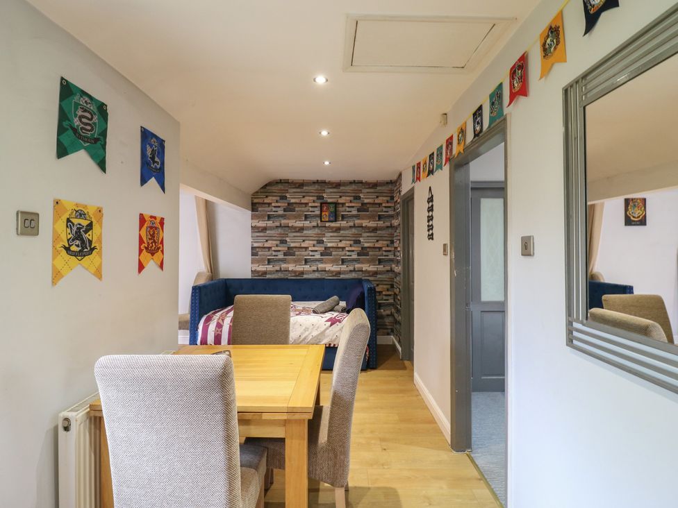 A dining room with a table and chairs at The Enchanted House in Watford