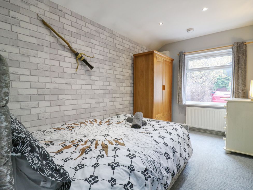 A bedroom with a bed and wardrobe at The Enchanted House in Watford