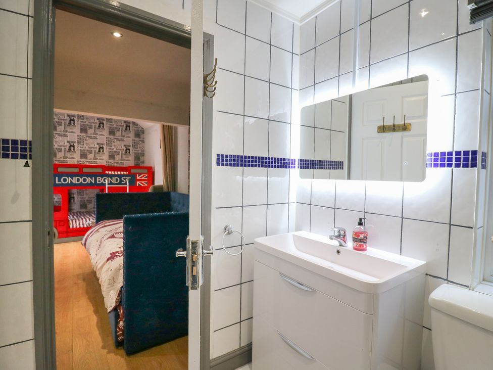 A bathroom with a sink and a mirror at The Enchanted House in Watford