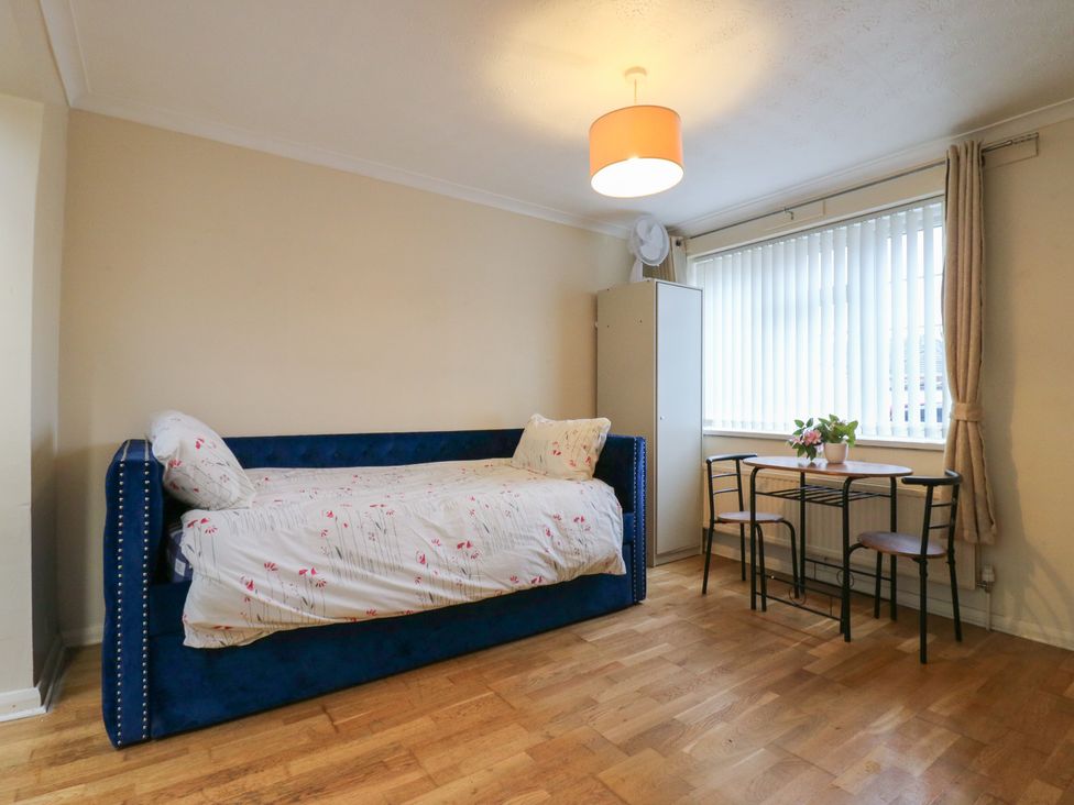 A bedroom with a bed and a table with chairs at Headmasters Hollow in Watford