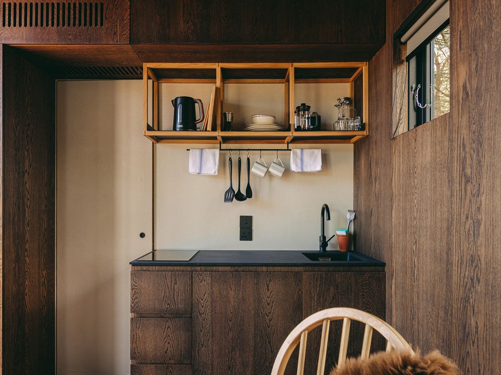 A kitchen with shelves and a sink at Red Squirrel in St. Andrews